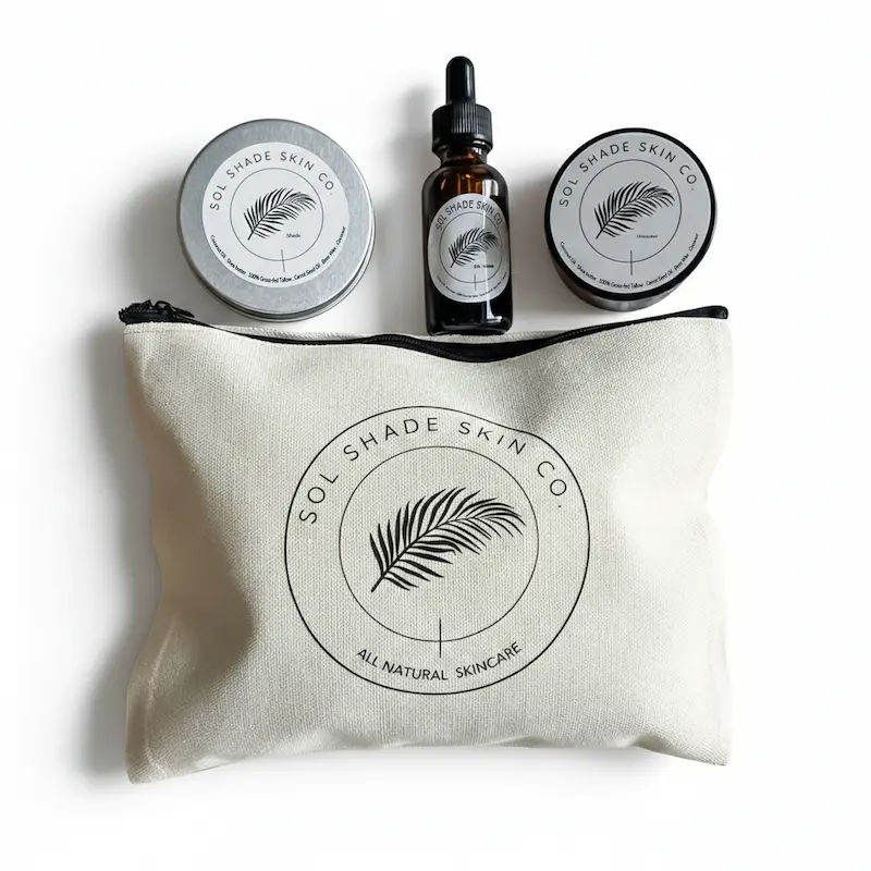 Sol Shade Skin Co skincare products including tins and a bottle on a branded pouch.