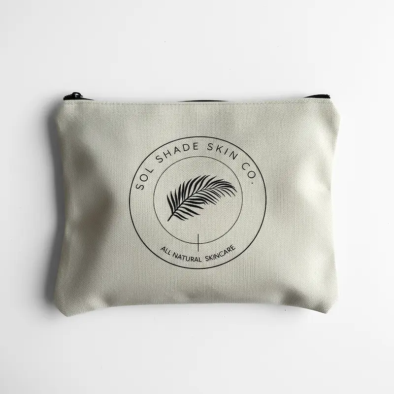 Beige pouch with Sol Shade Skin Co logo on a white background